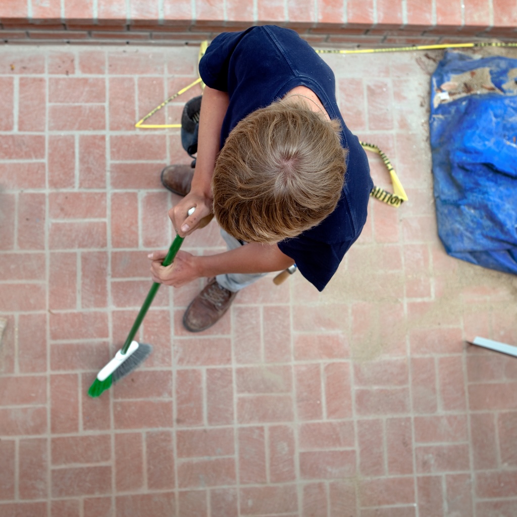 teenage-boy-sweepingn-on-construction-site-2025-04-03-17-53-01-utc