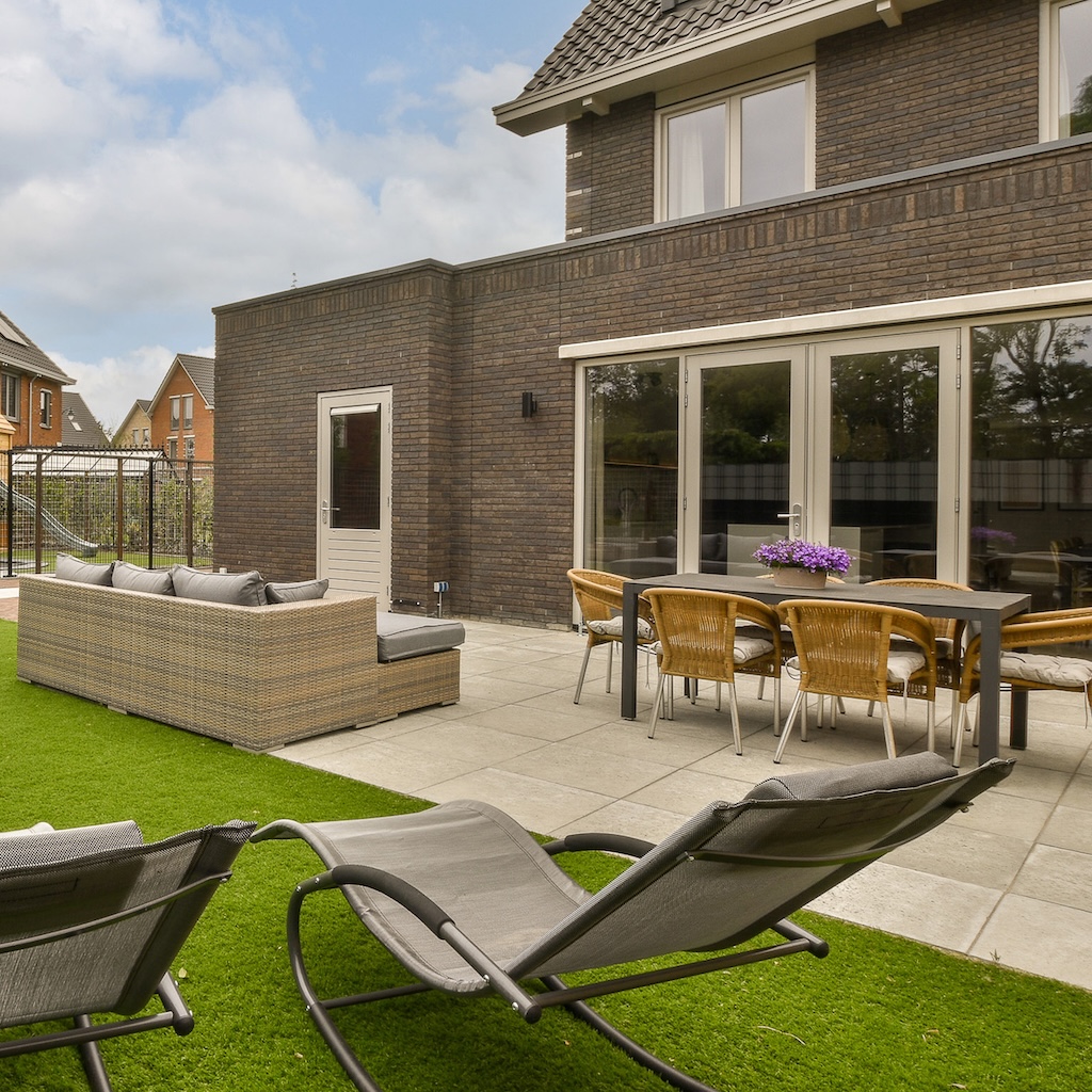 the-backyard-of-a-house-with-chairs-and-a-patio-2025-02-12-01-35-12-utc